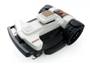 White and black robotic lawn mower with rugged tires and modern design.